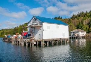 Old wooden building, Bornstein's fish delivery plant, built on wooden pilings over the ocean.